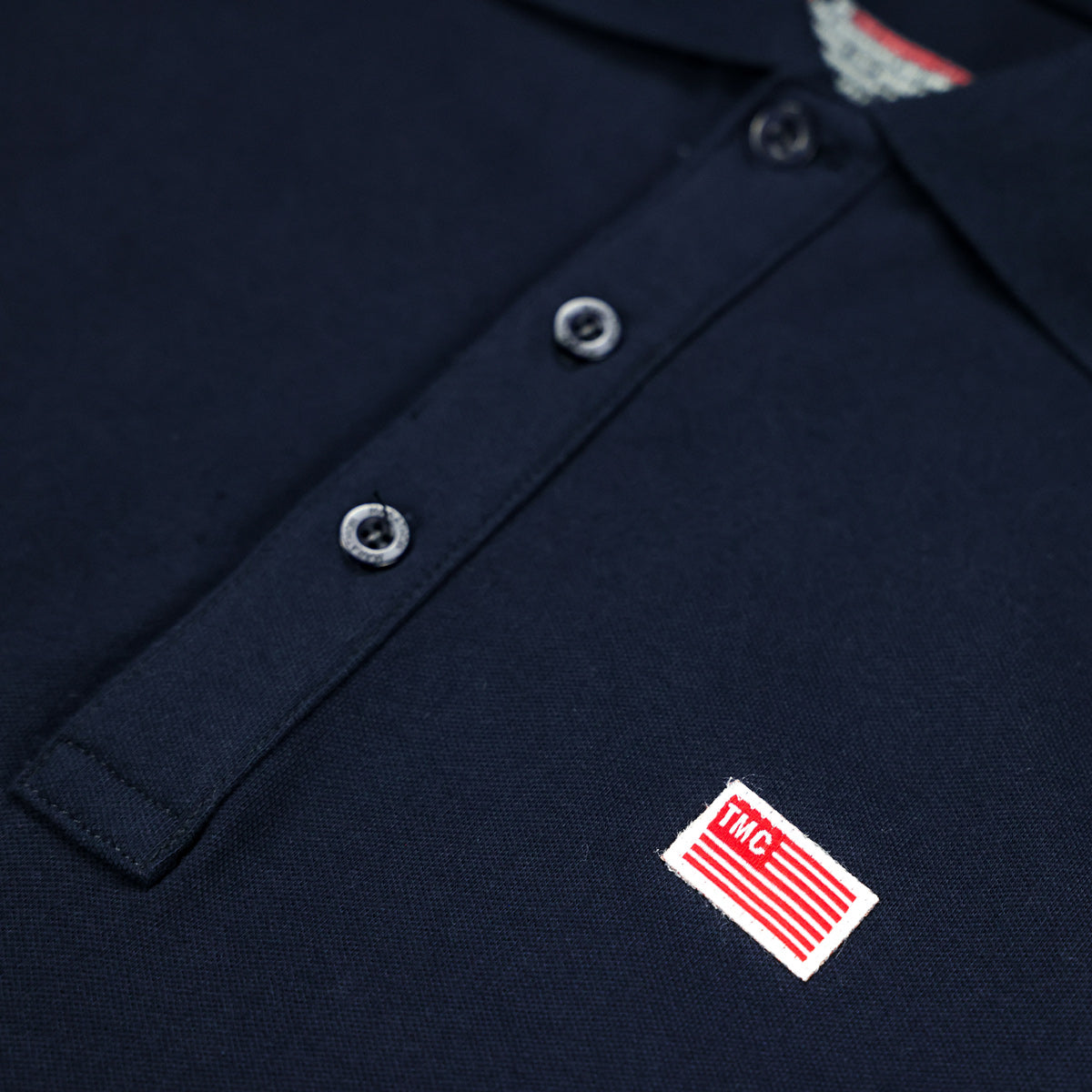 The Marathon Clothing TMC Flag (1 inch) Polo - Navy - Button Detail